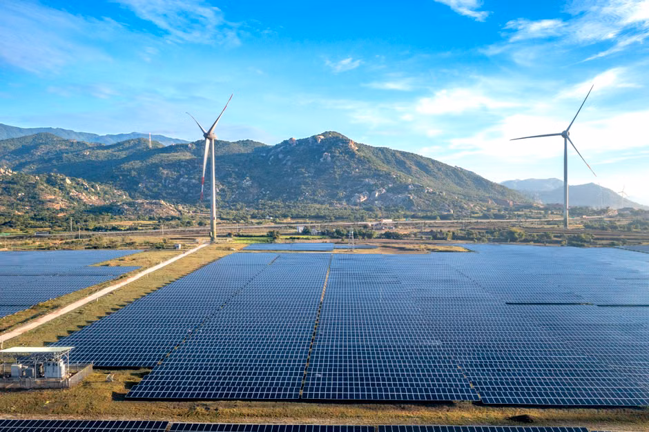 Aerial view of wind turbines and solar panels in Ninh Thuan, Vietnam, showcasing renewable energy.
