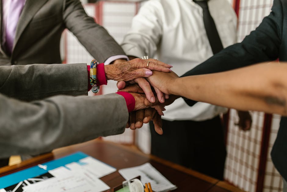 a diverse group of businesspeople uniting their hands symbol