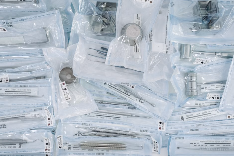 A collection of sterilized dental tools individually sealed in plastic wrap for hygiene.