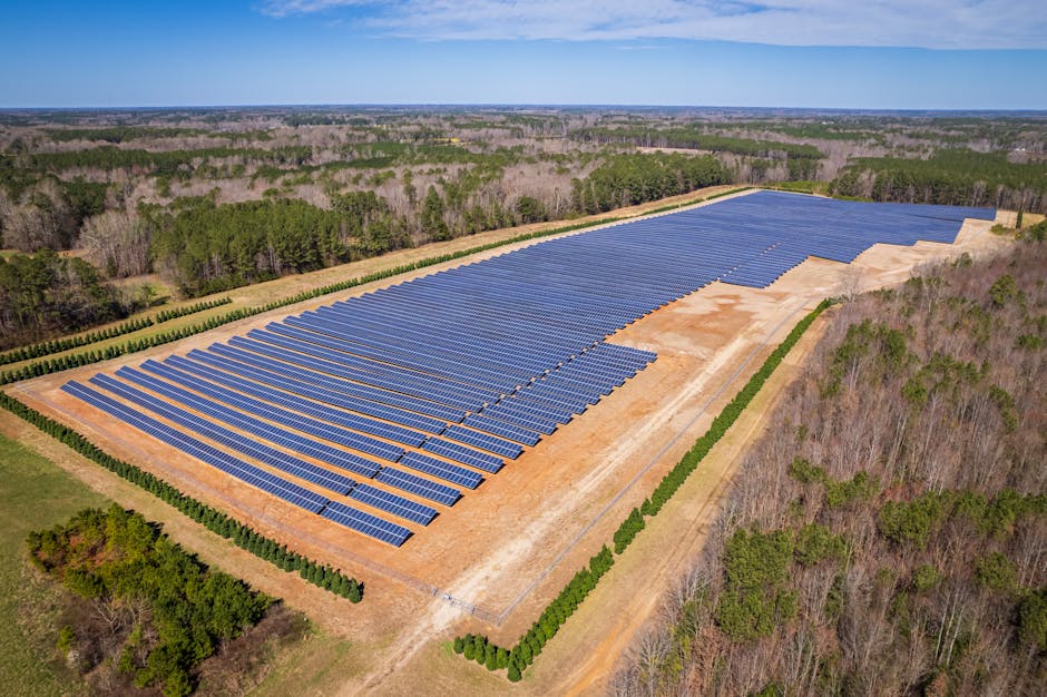 aerial drone shot of a large solar panel farm in a rural are